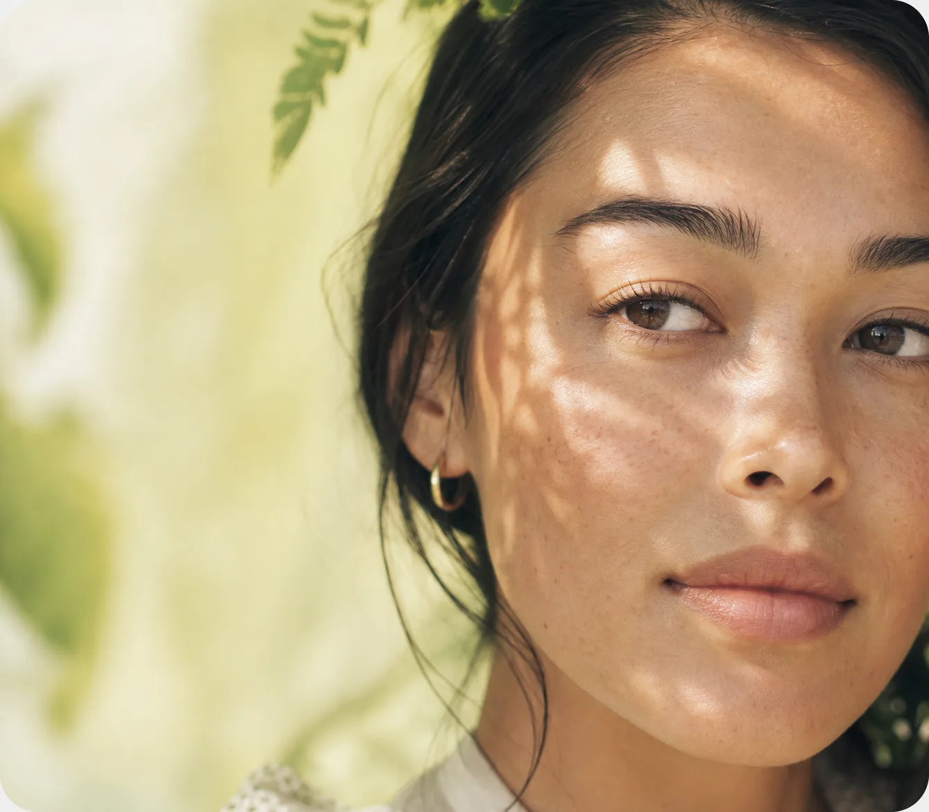 Woman in soft natural light with visible skin texture